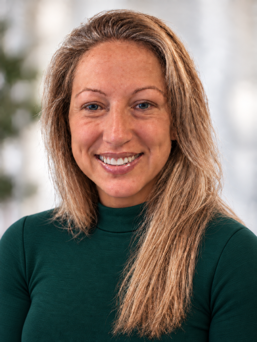 Professional portrait of Sheena Gilley in a dark green top